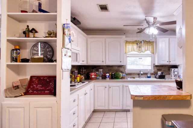 a kitchen with stainless steel appliances granite countertop a sink a stove and cabinets