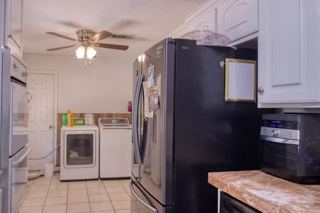 a kitchen with a refrigerator and a stove