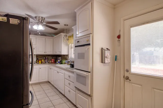 a kitchen with stainless steel appliances a refrigerator sink and cabinets