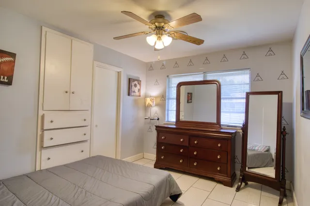 a bedroom with a bed and a dresser