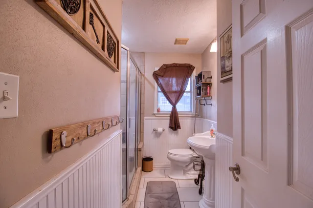 a bathroom with a toilet a sink and bathtub