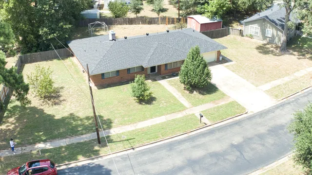 a view of a house with a floor to ceiling window and tree