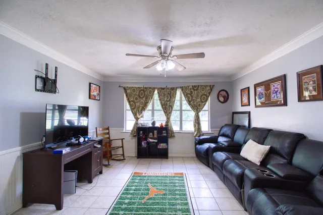 a living room with furniture and a flat screen tv