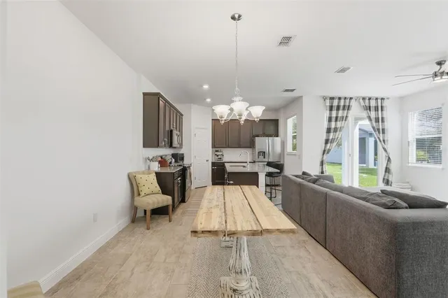 a large white kitchen with a large window and stainless steel appliances