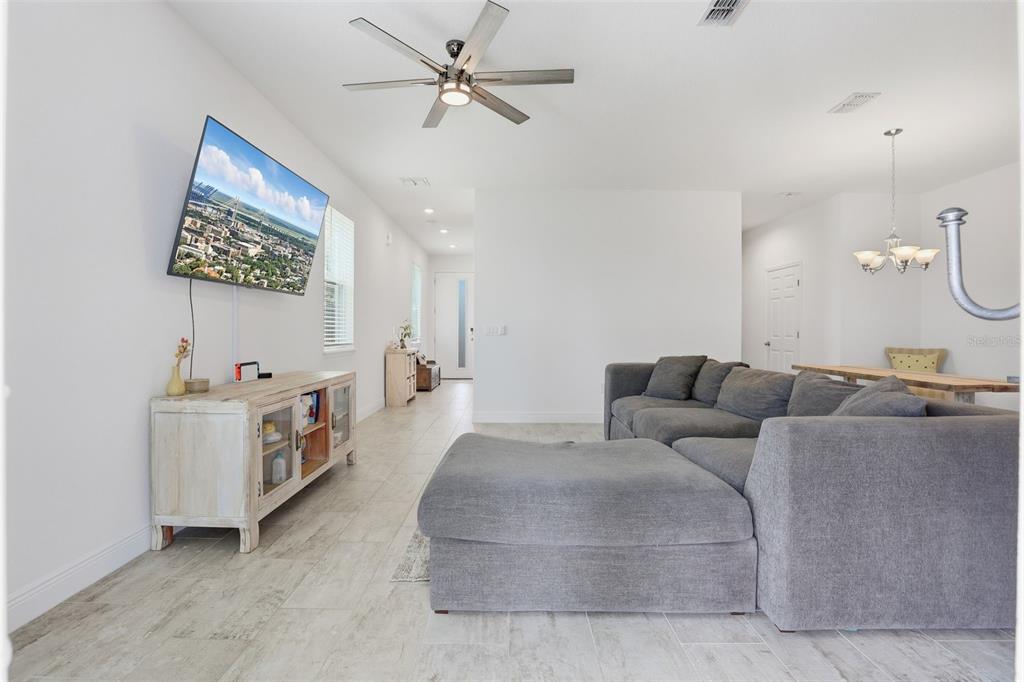 2420 Firstlight Way Winter Park, FL 32792 - Photo 12 of 48 a living room with furniture and a flat screen tv
