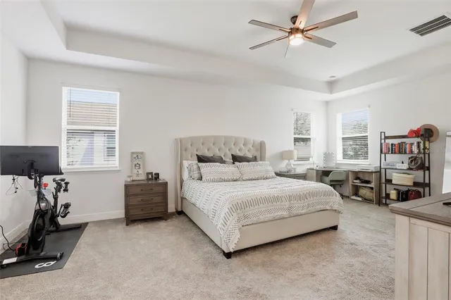 a bedroom with bed couch and a window