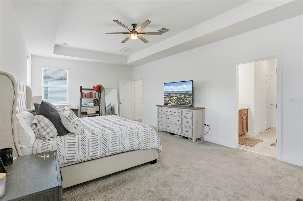 2420 Firstlight Way Winter Park, FL 32792 - Photo 17 of 48 a spacious bedroom with a bed a couch and dresser