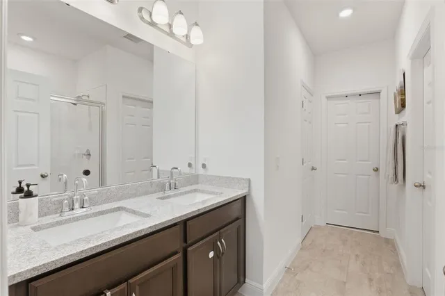 a bathroom with a sink double vanity and a mirror