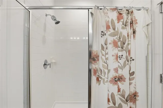 a bathroom with a shower and a shower curtain