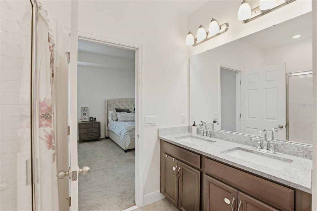 2420 Firstlight Way Winter Park, FL 32792 - Photo 20 of 48 a en suite bathroom with a sink double vanity and a mirror