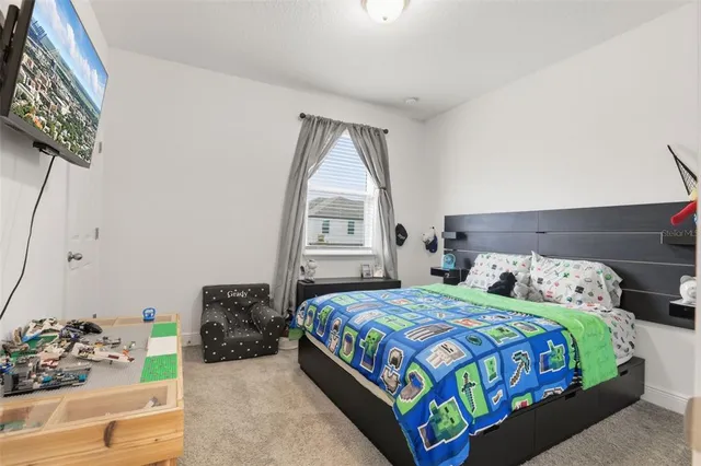 a bedroom with a bed mirror and window