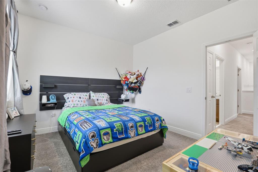 2420 Firstlight Way Winter Park, FL 32792 - Photo 24 of 48 a bedroom with a bed and a table in it