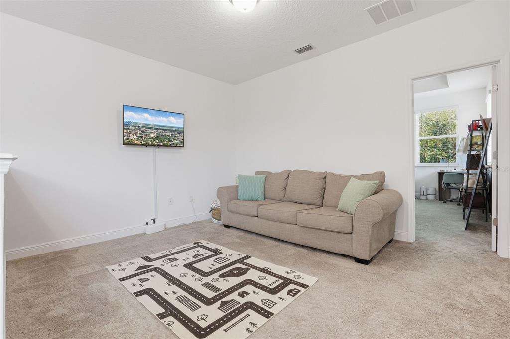 2420 Firstlight Way Winter Park, FL 32792 - Photo 27 of 48 a living room with furniture and a rug