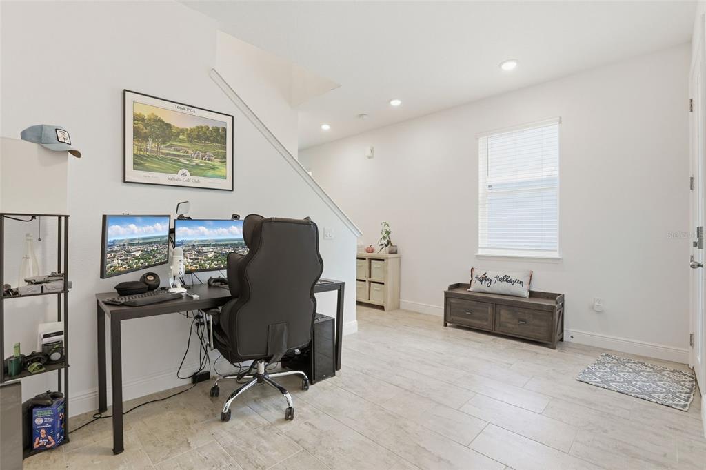 2420 Firstlight Way Winter Park, FL 32792 - Photo 3 of 48 a view of a workspace with furniture and a window