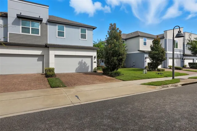 a view of a house with a yard and plants