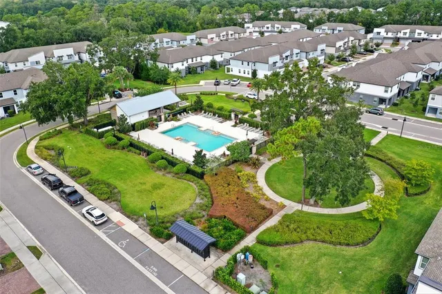 an aerial view of a residential houses with outdoor space and street view