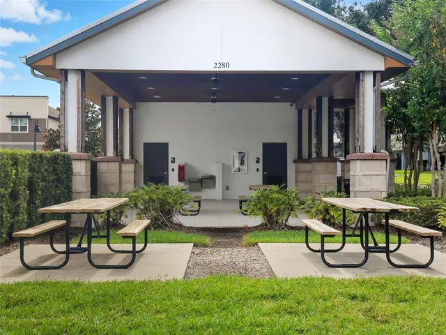 a view of house with backyard and outdoor seating