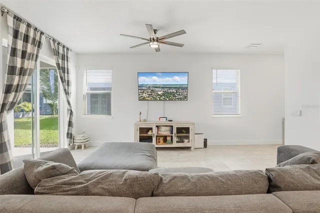 a living room with furniture and a large window