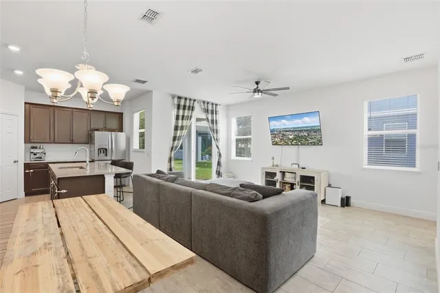 a living room with stainless steel appliances kitchen island granite countertop furniture and a fireplace