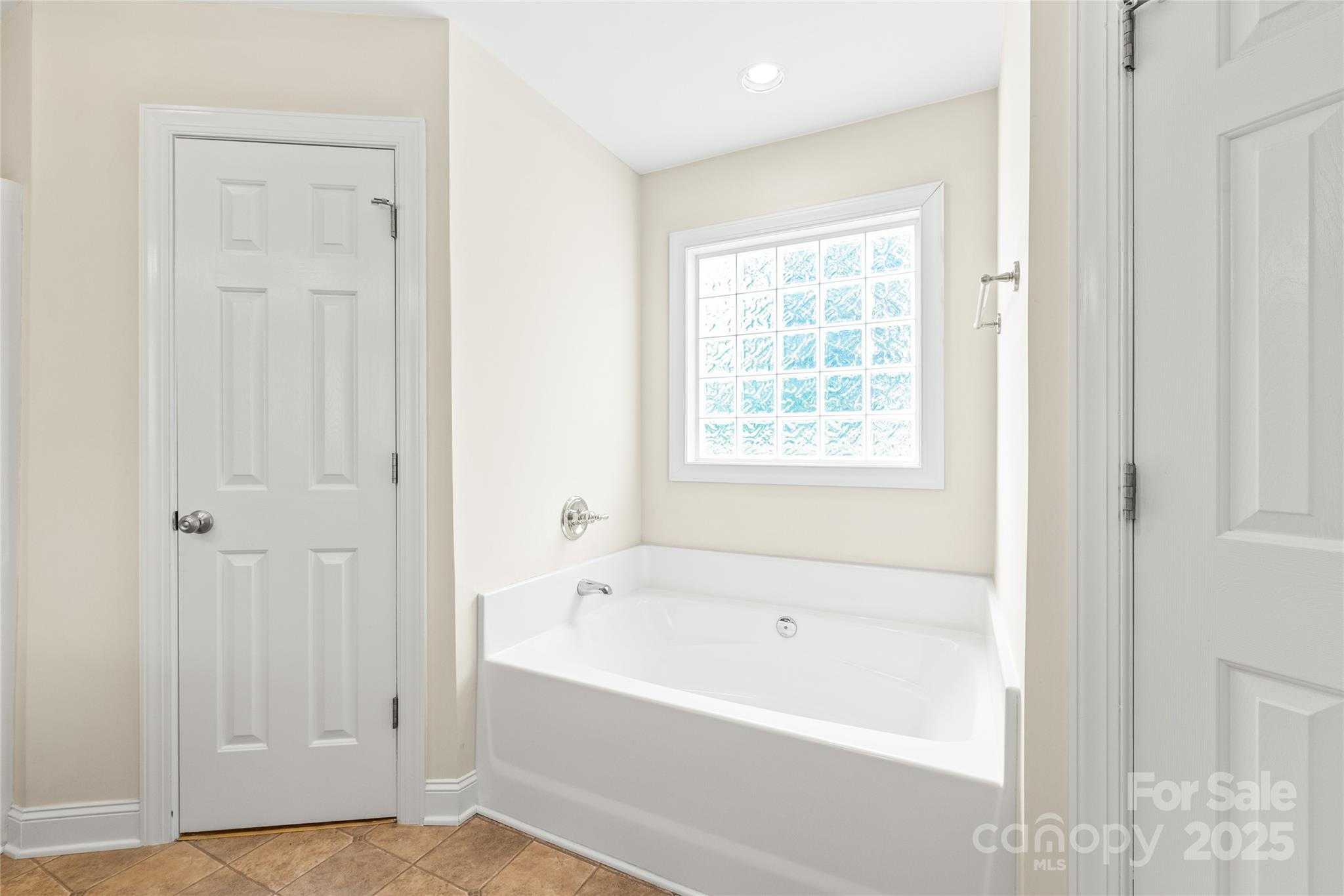 8717 Swift Road Oakboro, NC 28129 - Photo 11 of 23 a white bath tub sitting next to a window