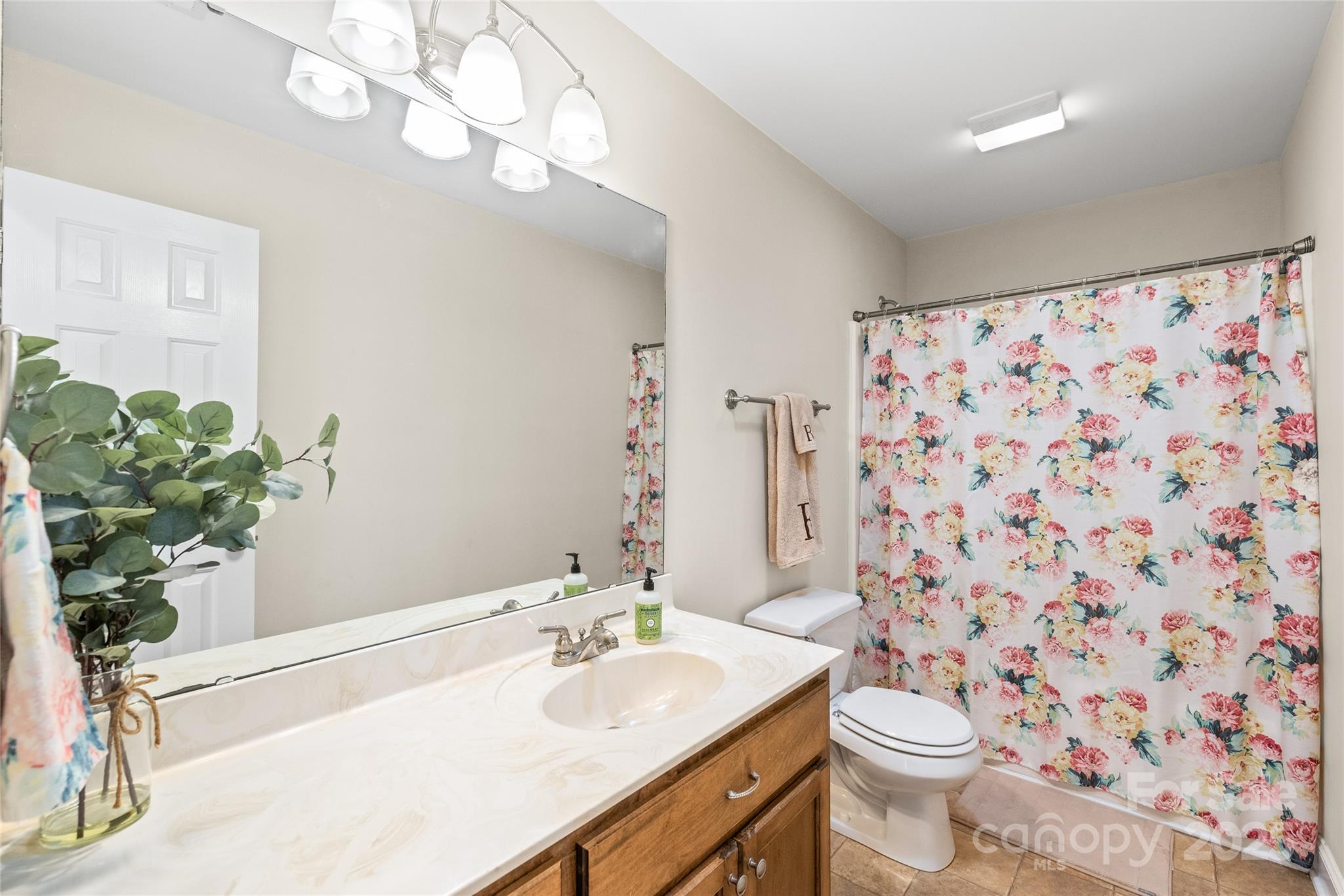 8717 Swift Road Oakboro, NC 28129 - Photo 13 of 23 a bathroom with a sink a toilet and a mirror