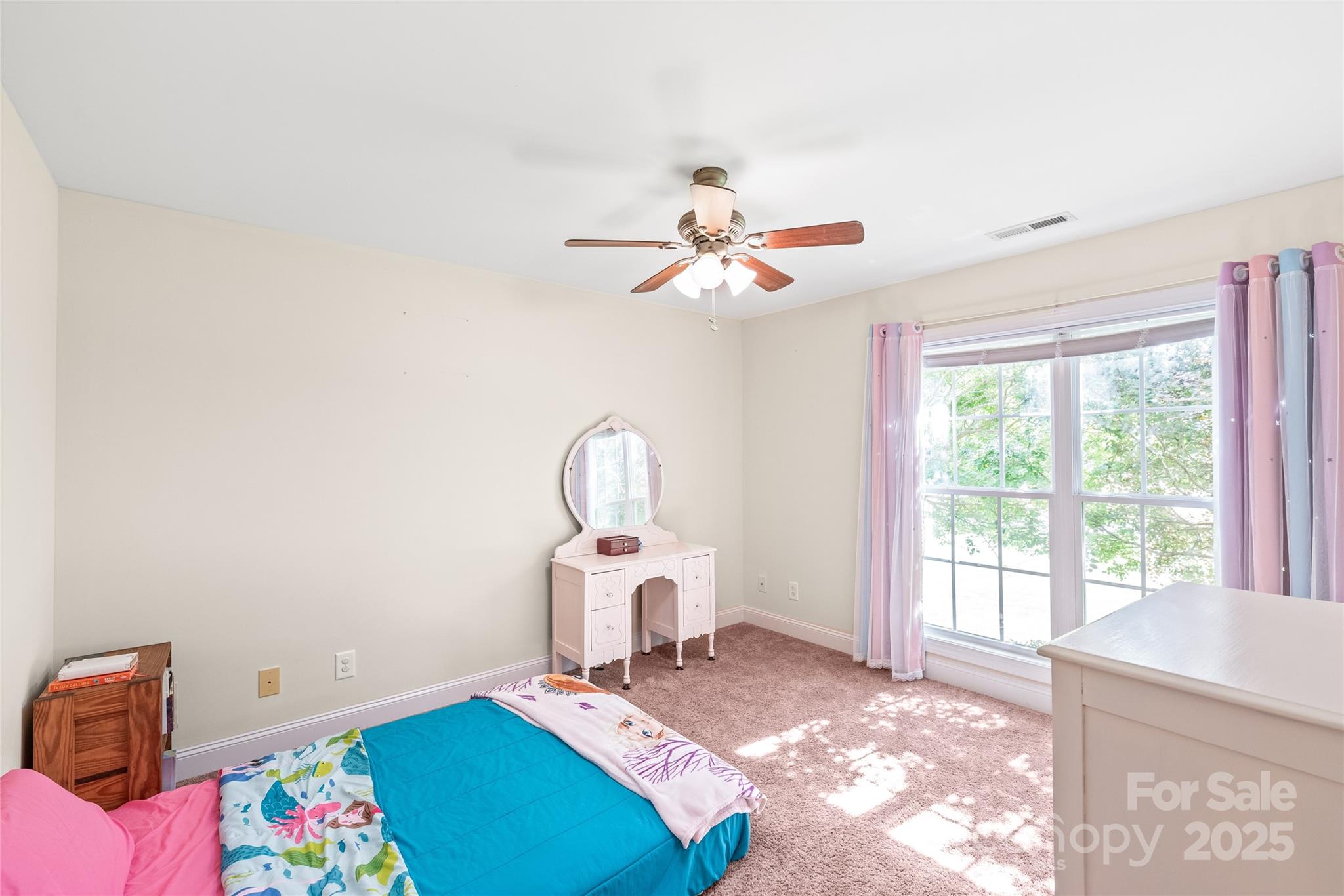 8717 Swift Road Oakboro, NC 28129 - Photo 14 of 23 a bedroom with a bed and a chandelier