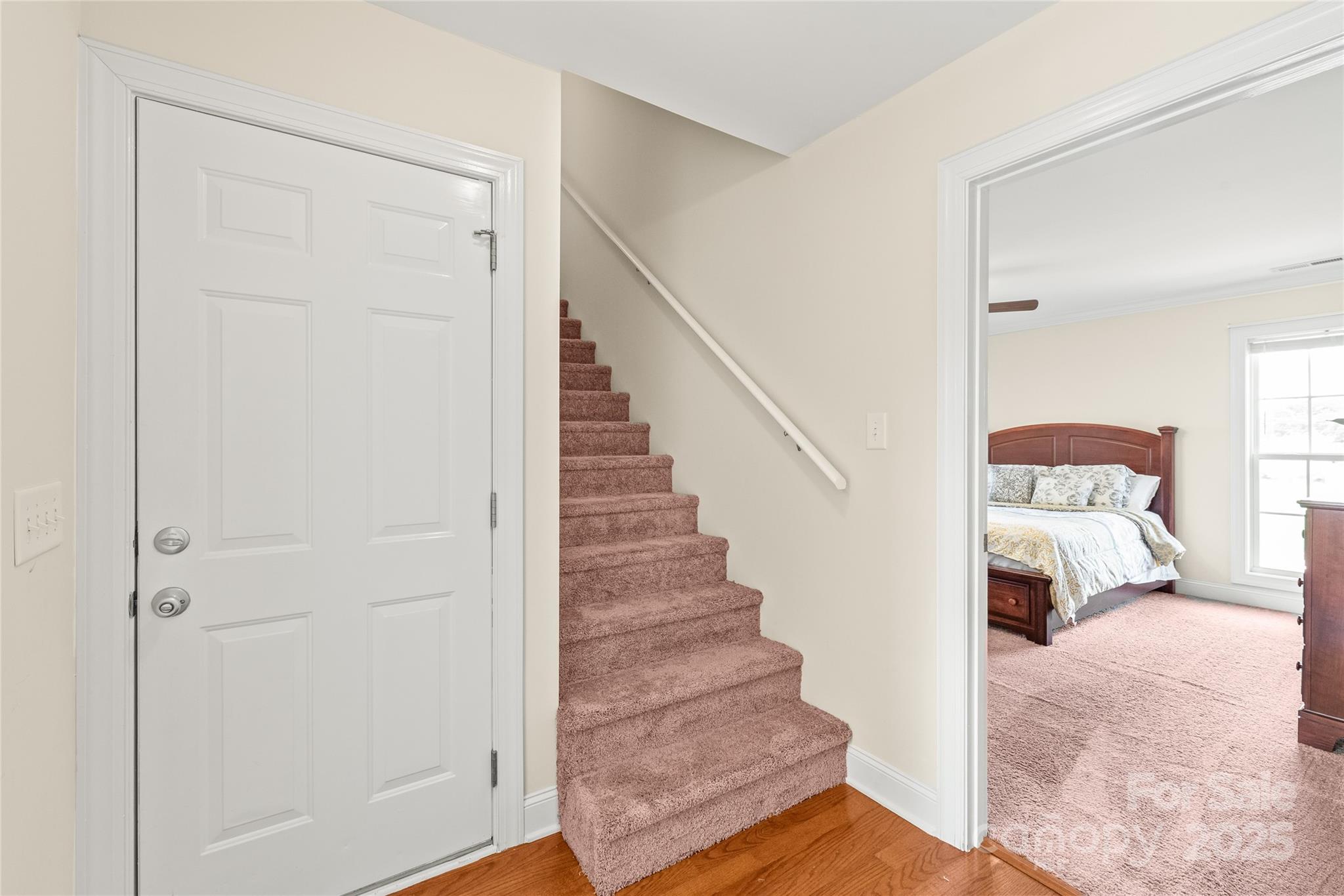 8717 Swift Road Oakboro, NC 28129 - Photo 15 of 23 a view of entryway and bedroom with wooden floor