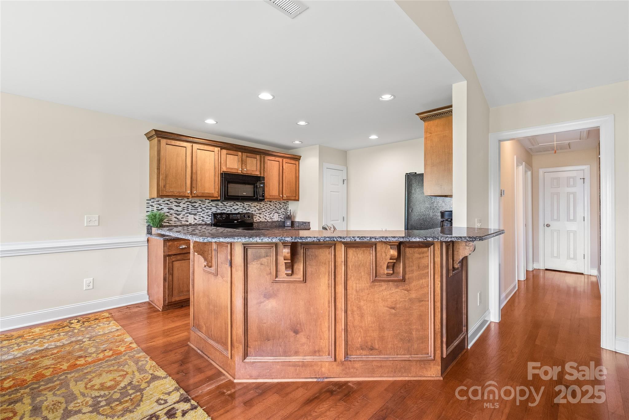8717 Swift Road Oakboro, NC 28129 - Photo 5 of 23 a kitchen with stainless steel appliances granite countertop a refrigerator and a stove top oven