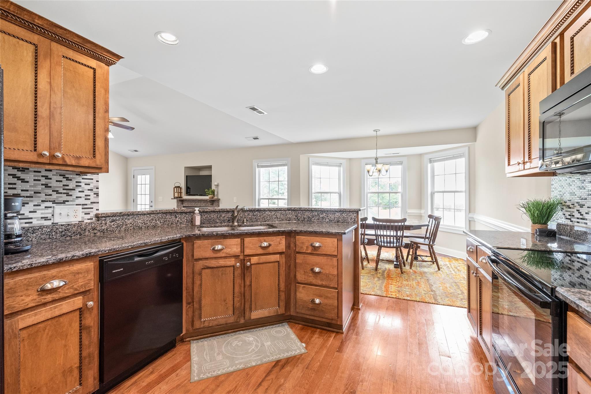 8717 Swift Road Oakboro, NC 28129 - Photo 7 of 23 a kitchen with lots of counter top space and dining table