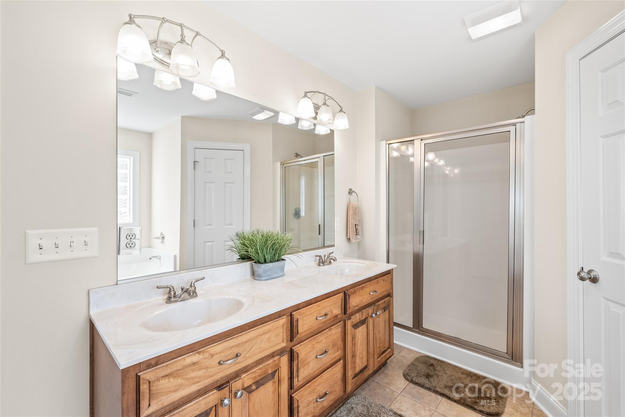 8717 Swift Road Oakboro, NC 28129 - Photo 10 of 23 a bathroom with a sink double vanity and a mirror