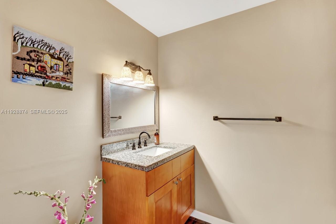 5170 Nesting Way, Unit B Delray Beach, FL 33484 - Photo 12 of 16 a bathroom with a sink and a mirror