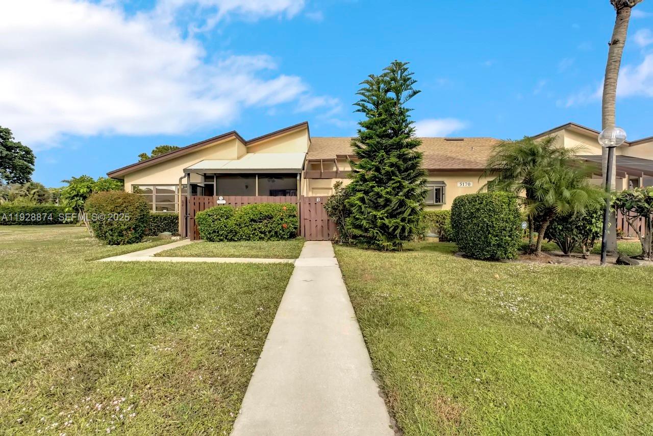 5170 Nesting Way, Unit B Delray Beach, FL 33484 - Photo 14 of 16 a front view of a house with garden