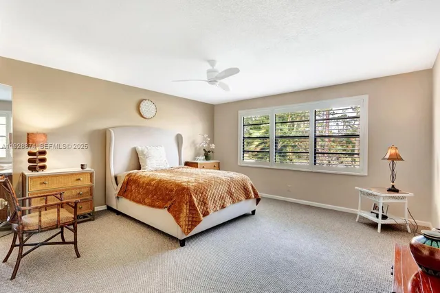 a bedroom with a bed and closet with mirror