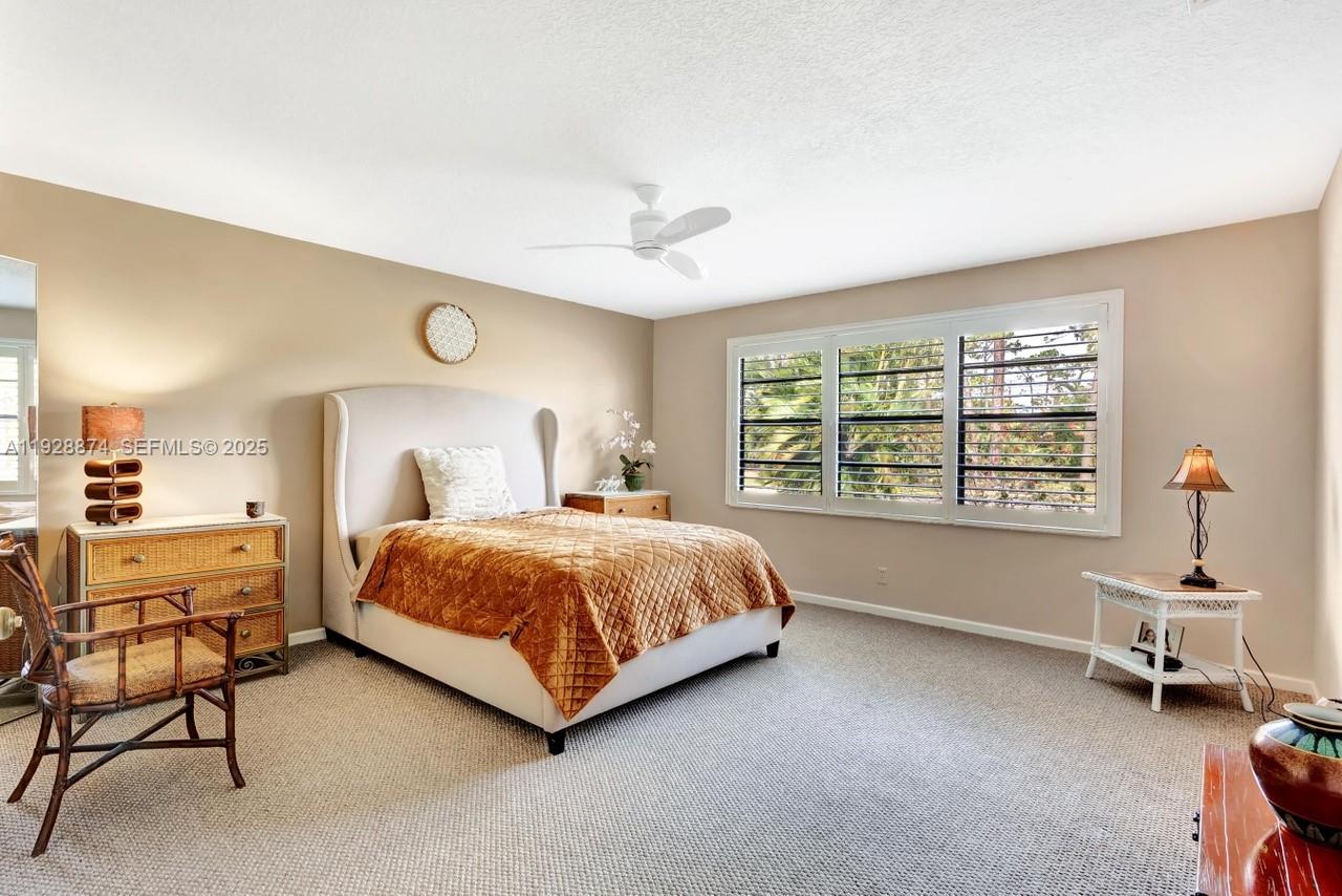 5170 Nesting Way, Unit B Delray Beach, FL 33484 - Photo 10 of 16 a bedroom with a bed and a chair in it