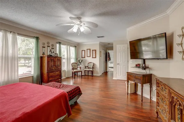 a bedroom with furniture and a flat screen tv