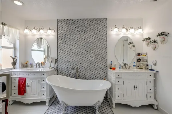 a bathroom with a sink mirror and vanity