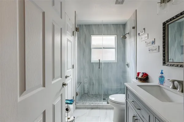 a bathroom with a sink toilet and shower