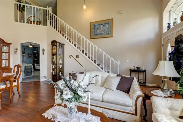 a living room with furniture and wooden floor