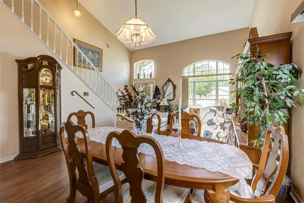 a view of a dining room with furniture and chandelier