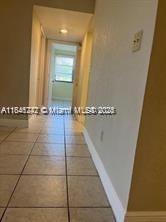 20850 San Simeon Way, Unit 3095 Miami, FL 33179 - Photo 13 of 20 a view of a livingroom with a flesh screen tv and window