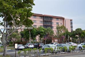 20850 San Simeon Way, Unit 3095 Miami, FL 33179 - Photo 18 of 20 a front view of a building with garden and trees