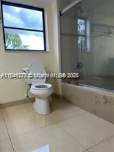 20850 San Simeon Way, Unit 3095 Miami, FL 33179 - Photo 3 of 20 a bathroom with a toilet sink and mirror