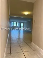 a view of a hallway with a chair and table