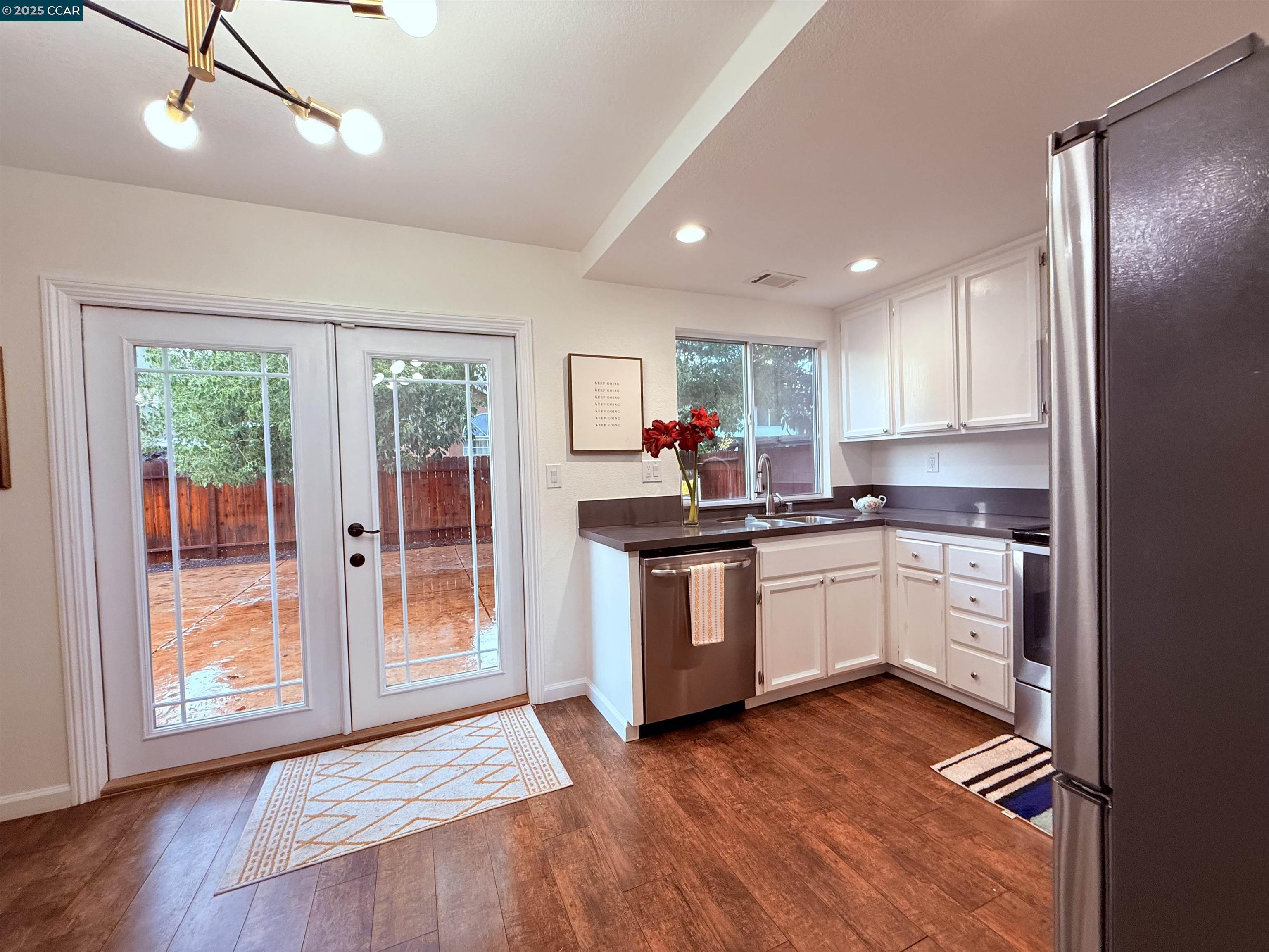 360 Gull Place Pittsburg, CA 94565 - Photo 11 of 36 a kitchen with granite countertop a stove a sink and a refrigerator