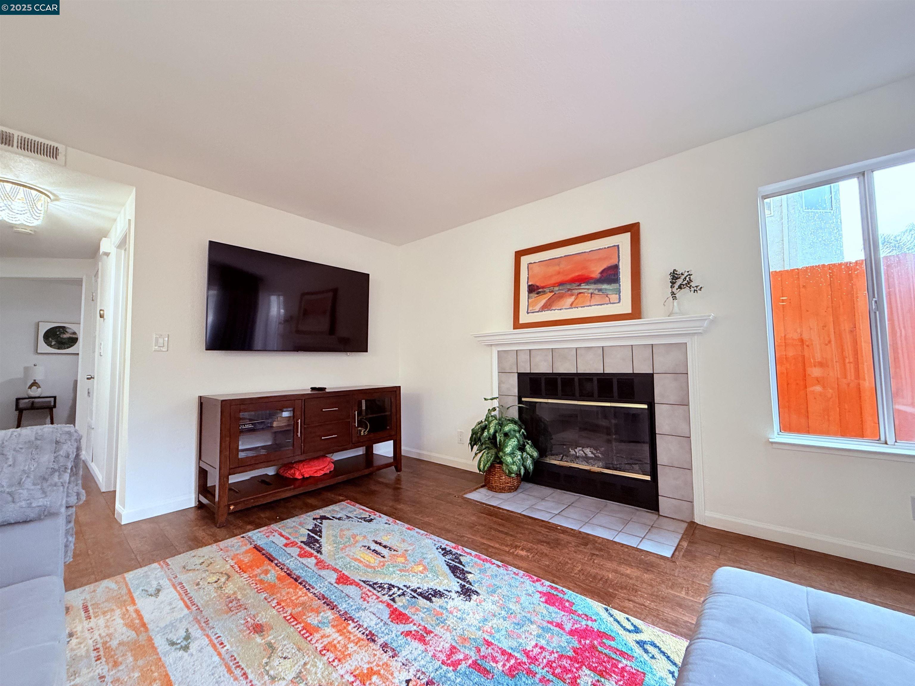 360 Gull Place Pittsburg, CA 94565 - Photo 8 of 36 a living room with furniture a flat screen tv and a fireplace