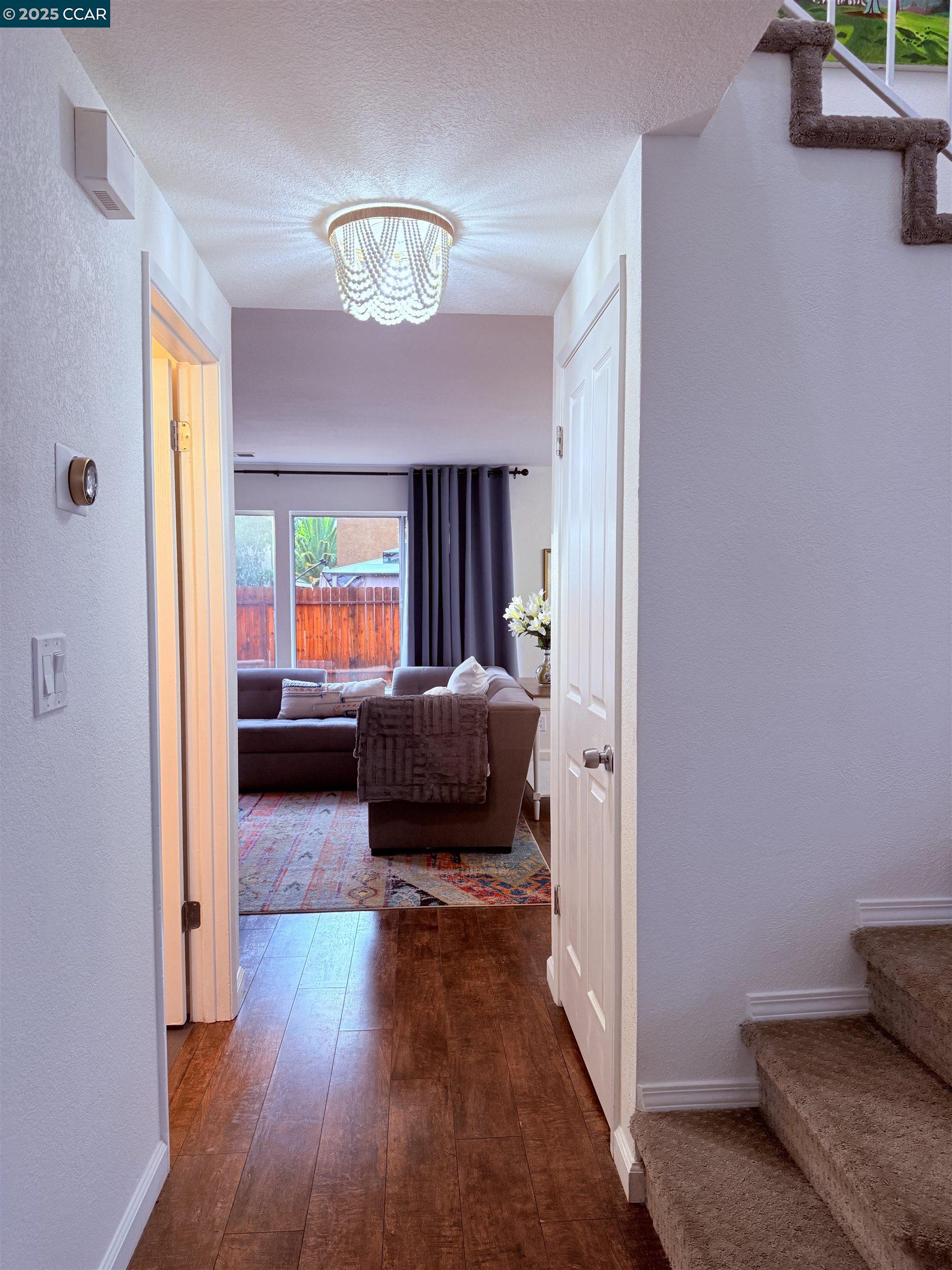 360 Gull Place Pittsburg, CA 94565 - Photo 9 of 36 a living room with furniture and a chandelier