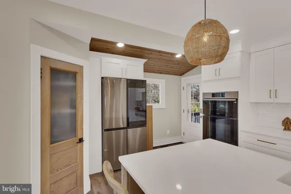 a kitchen with stainless steel appliances a refrigerator and microwave