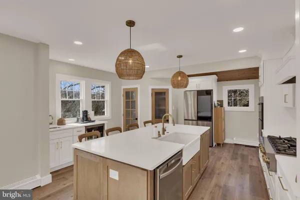 a view of a kitchen counter space a sink and wooden floor