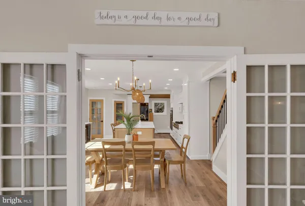 a view of a living room and kitchen with furniture wooden floor and window