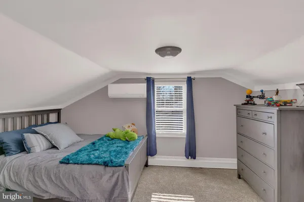 a bed room with a bed and a window